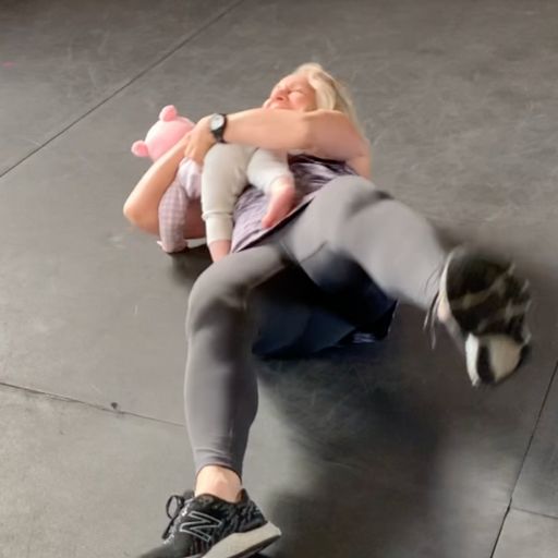 grandma rolling on ground with grandchild